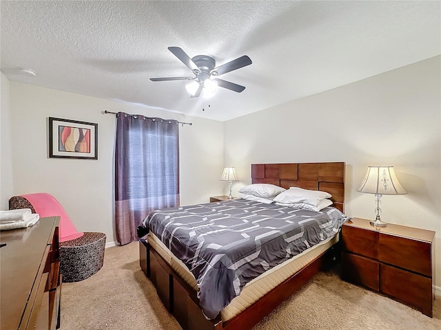 carpeted bedroom featuring a textured ceiling and ceiling fan