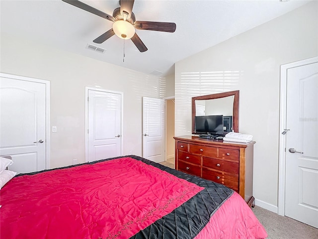 carpeted bedroom with ceiling fan and vaulted ceiling