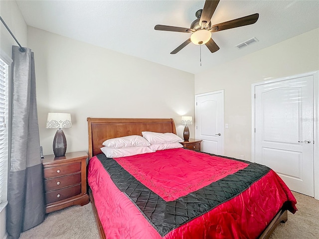 bedroom with ceiling fan and light carpet