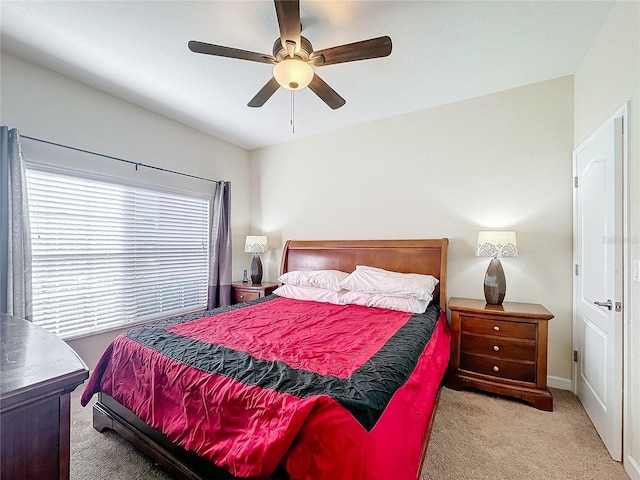 bedroom with ceiling fan and light carpet