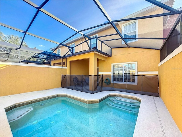 view of swimming pool with glass enclosure