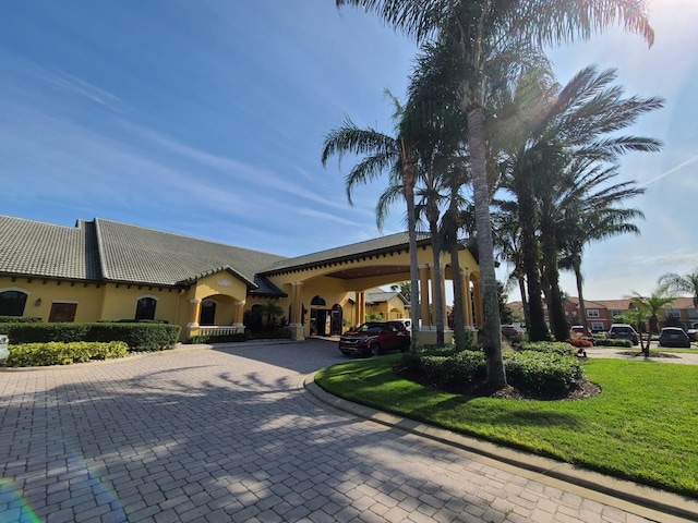 exterior space with a carport and a front lawn