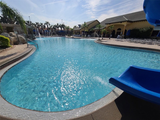 view of pool featuring a patio area and a water slide