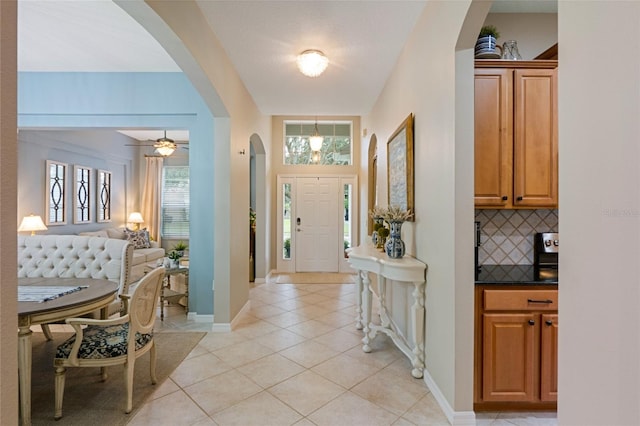 entrance foyer featuring light tile patterned floors, plenty of natural light, and ceiling fan