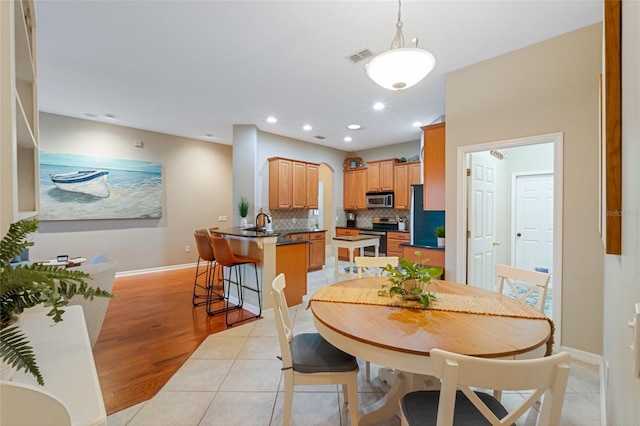 dining space featuring light tile patterned floors