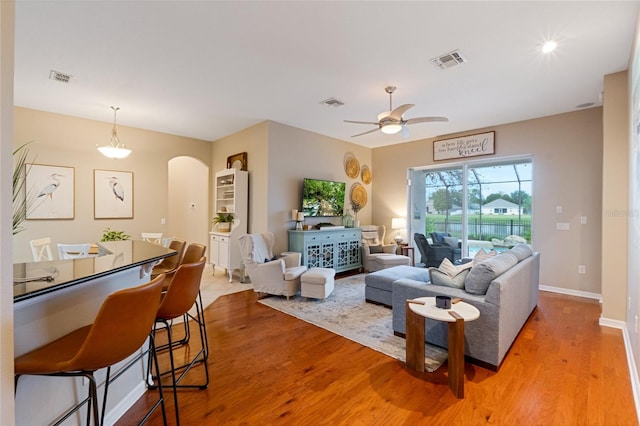 living room featuring ceiling fan and light wood-type flooring