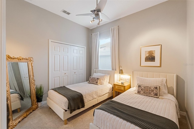 carpeted bedroom with ceiling fan and a closet