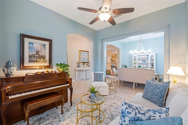 sitting room featuring light tile patterned floors and ceiling fan with notable chandelier