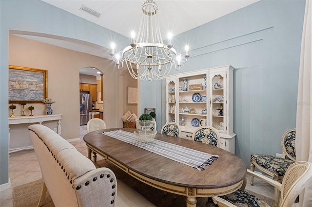 tiled dining area with a notable chandelier