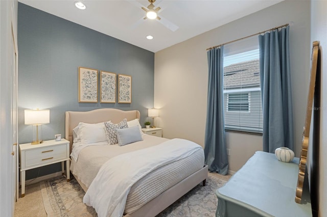 bedroom featuring ceiling fan and light carpet