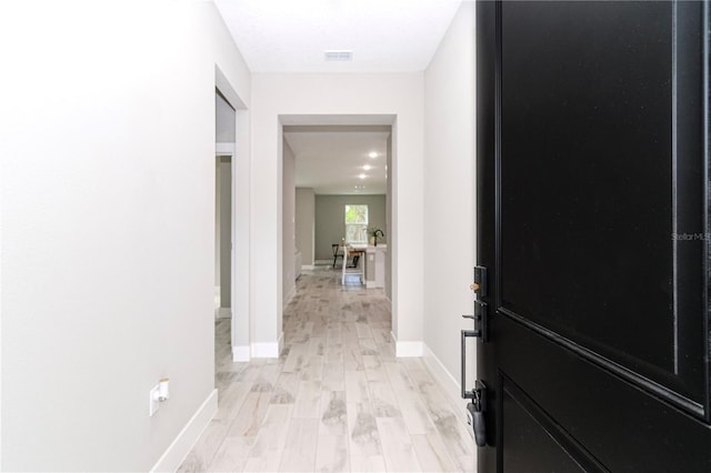 hall with light hardwood / wood-style flooring