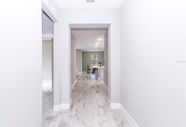 corridor featuring light hardwood / wood-style floors