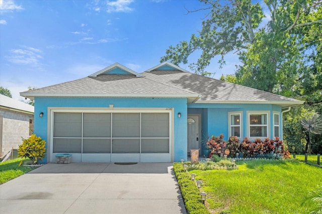 view of front of home with a garage and a front yard