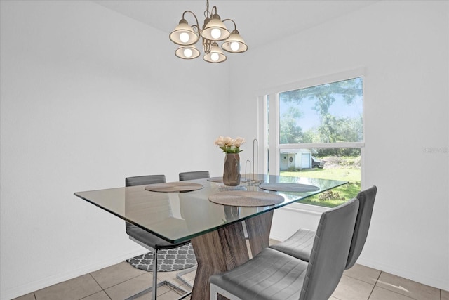 tiled dining space featuring an inviting chandelier