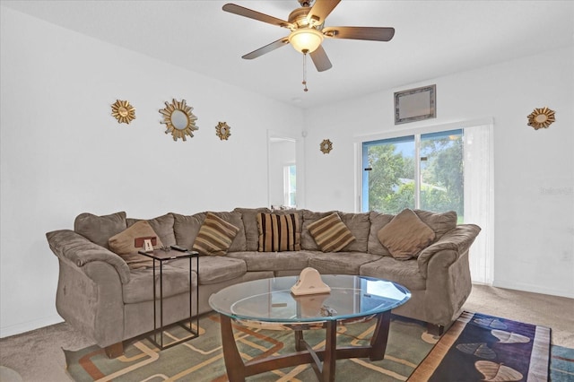 carpeted living room featuring ceiling fan