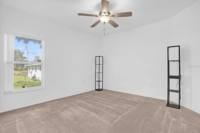 spare room featuring ceiling fan, a healthy amount of sunlight, and light carpet