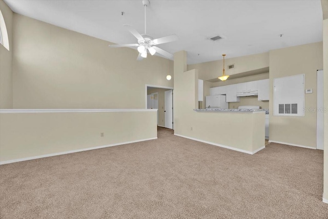 unfurnished living room with ceiling fan and light colored carpet