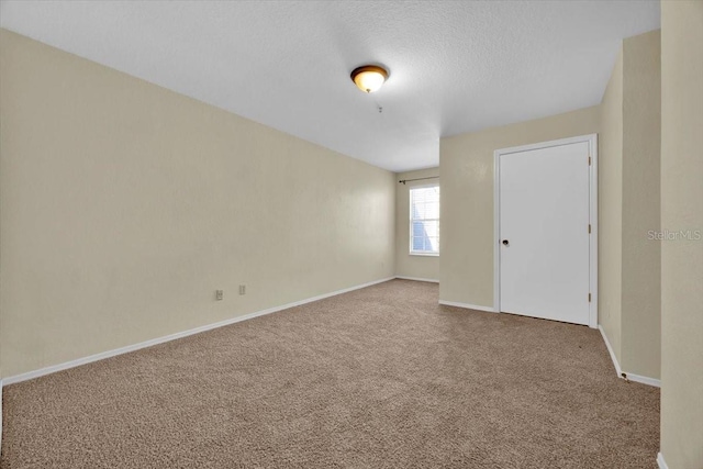 spare room with carpet floors and a textured ceiling