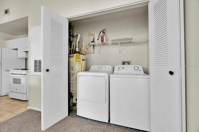 laundry area featuring light carpet, separate washer and dryer, and water heater