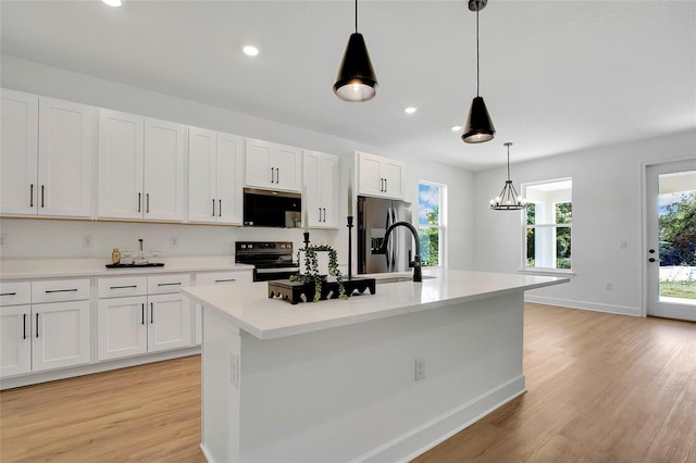 kitchen with white cabinets, an island with sink, and appliances with stainless steel finishes