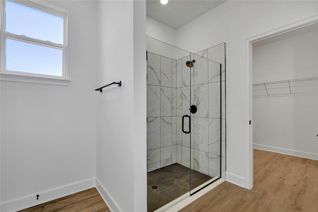 bathroom with hardwood / wood-style floors and a shower with door