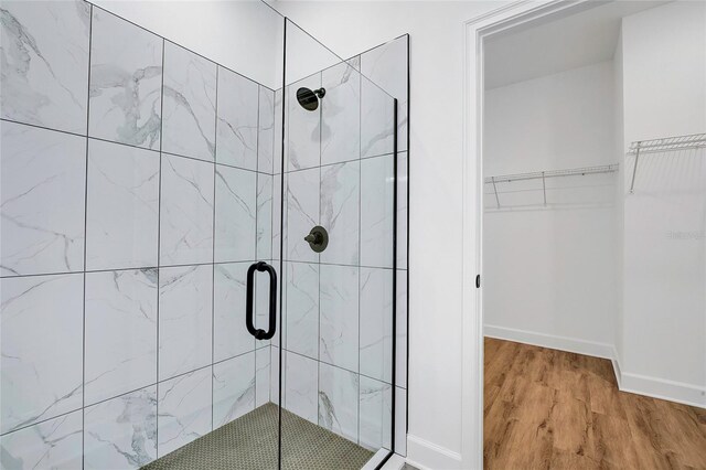 bathroom featuring hardwood / wood-style floors and an enclosed shower