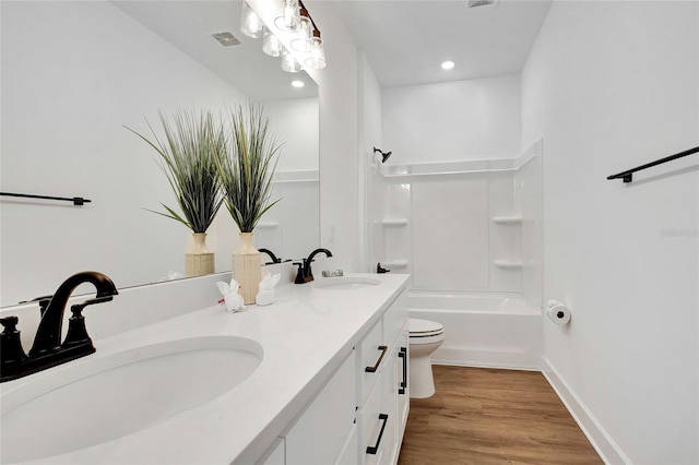 full bathroom featuring shower / bathing tub combination, wood-type flooring, vanity, and toilet