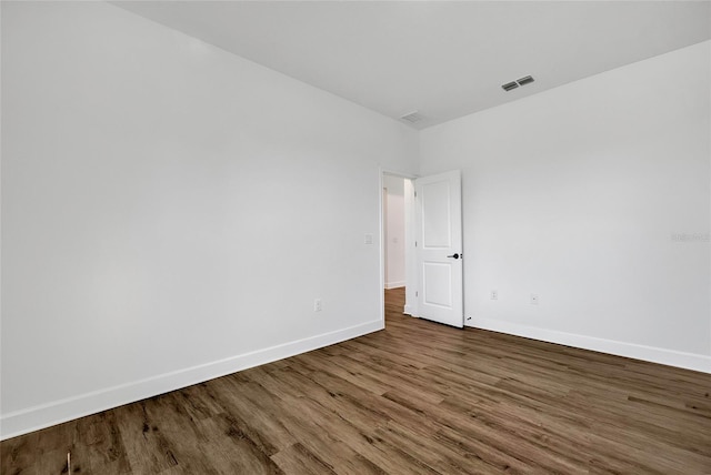 unfurnished room featuring dark wood-type flooring