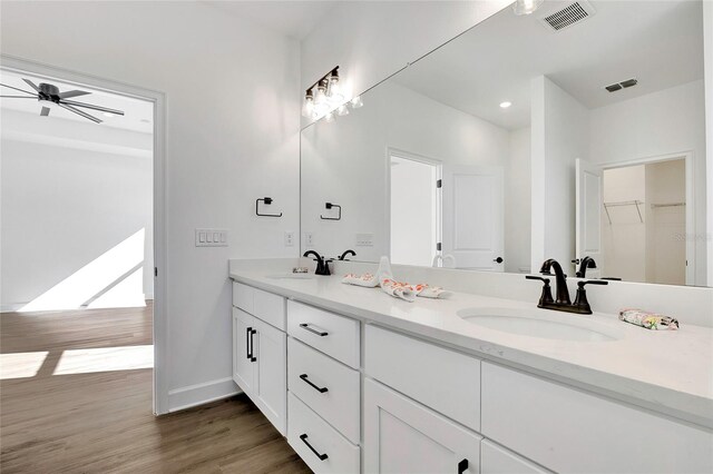 bathroom featuring ceiling fan, vanity, and hardwood / wood-style flooring