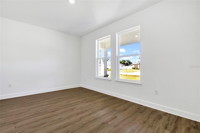 empty room with dark hardwood / wood-style flooring