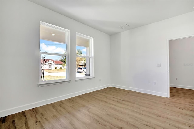 empty room with light hardwood / wood-style flooring