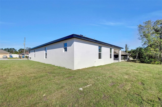 view of side of property with a yard