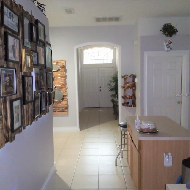 foyer featuring light tile patterned flooring