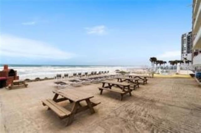 view of community with a beach view and a water view