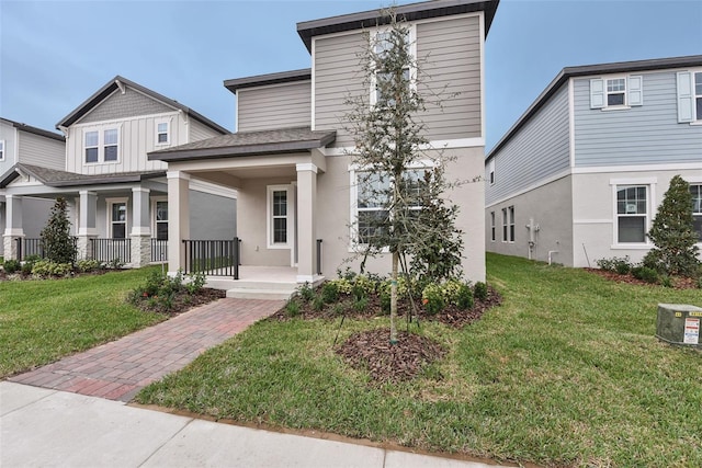 view of front of home with a front lawn and covered porch