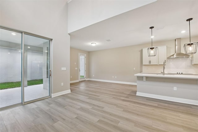 unfurnished living room featuring light hardwood / wood-style floors and a healthy amount of sunlight