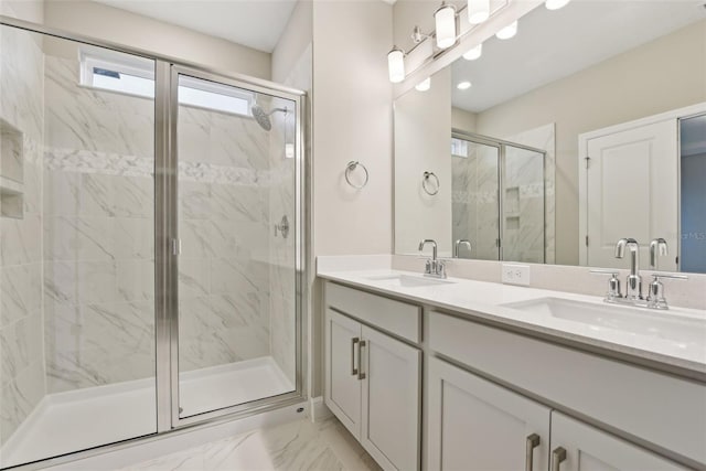 bathroom with a shower with door and vanity