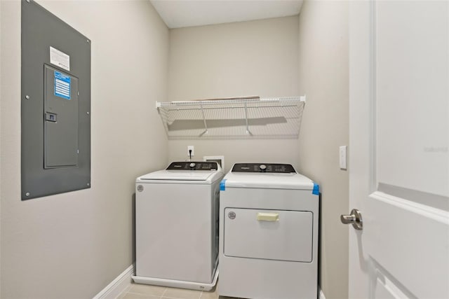 laundry area with separate washer and dryer, light tile patterned floors, and electric panel