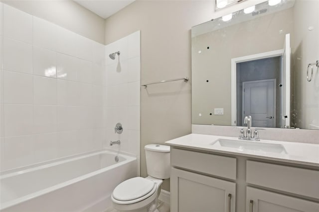 full bathroom featuring vanity, tiled shower / bath combo, and toilet