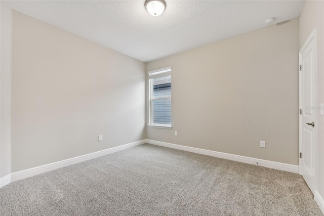 carpeted spare room featuring a textured ceiling