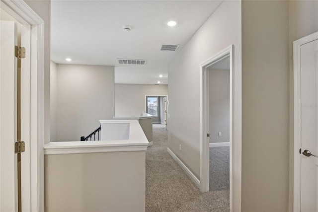 hallway featuring light carpet