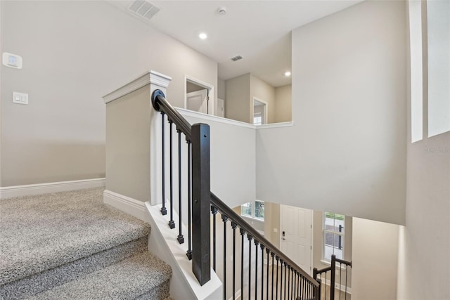 stairway featuring carpet flooring