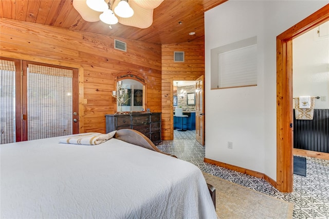 carpeted bedroom with ceiling fan, wood walls, wood ceiling, and vaulted ceiling