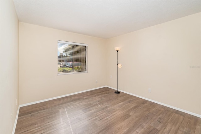 empty room with hardwood / wood-style flooring