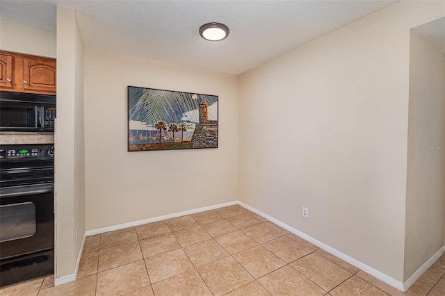 tiled dining space with a textured ceiling