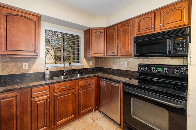 kitchen with tasteful backsplash, dark stone countertops, sink, and black appliances