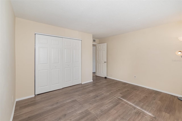 unfurnished bedroom with a closet and light wood-type flooring