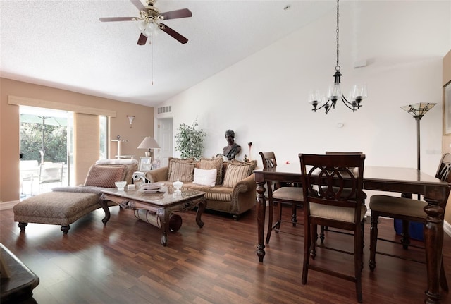 living room with a textured ceiling, ceiling fan with notable chandelier, dark wood-type flooring, and vaulted ceiling