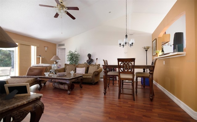 dining area with ceiling fan with notable chandelier, lofted ceiling, and dark wood-type flooring