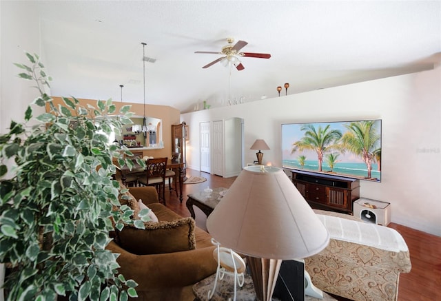 living room with hardwood / wood-style floors, ceiling fan, and lofted ceiling